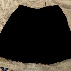 Pleated above knee skirt.